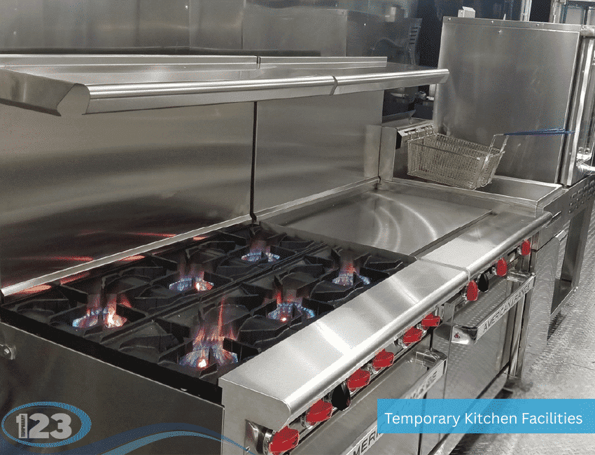 Commercial kitchen range with burners and adjacent work surfaces